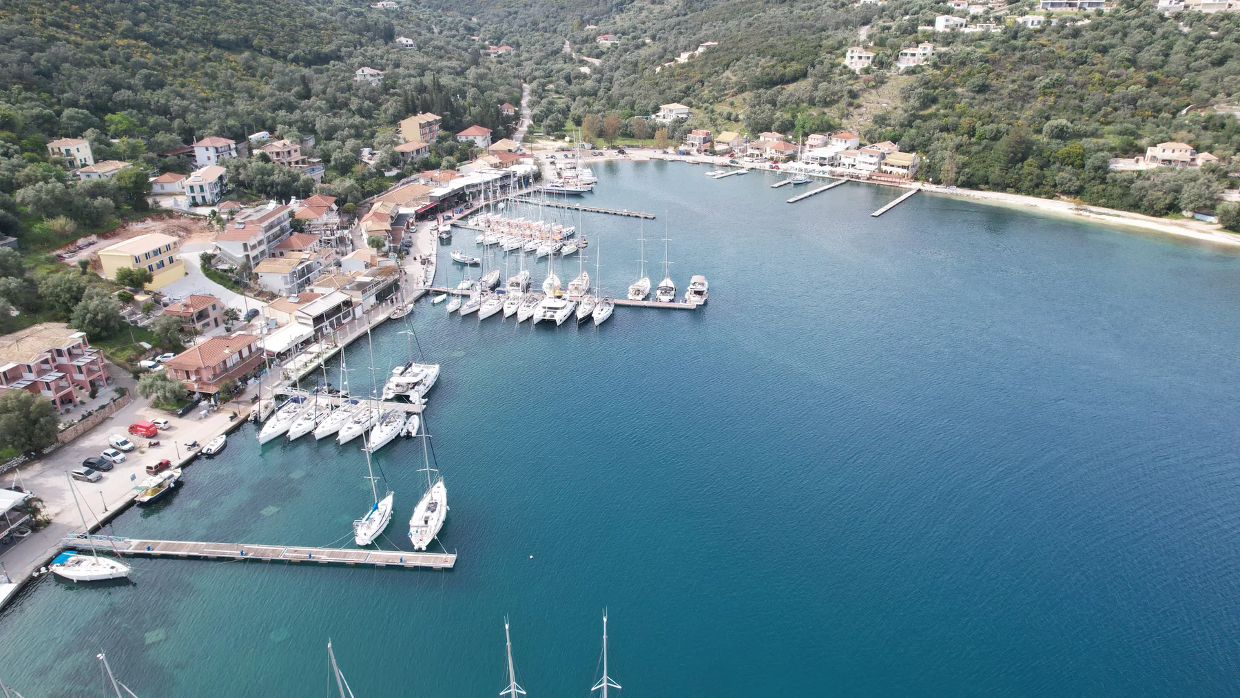 Drone view of a waterfront harbour with moored sailing yachts