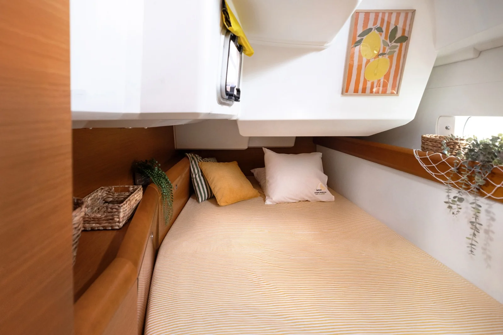 A double cabin aboard YOLO's Lemon sailing yacht with bedding and compact storage