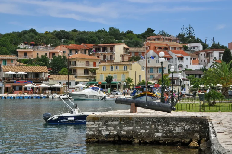Kassiopi harbour on Corfu with waterfront buildings and moored boats