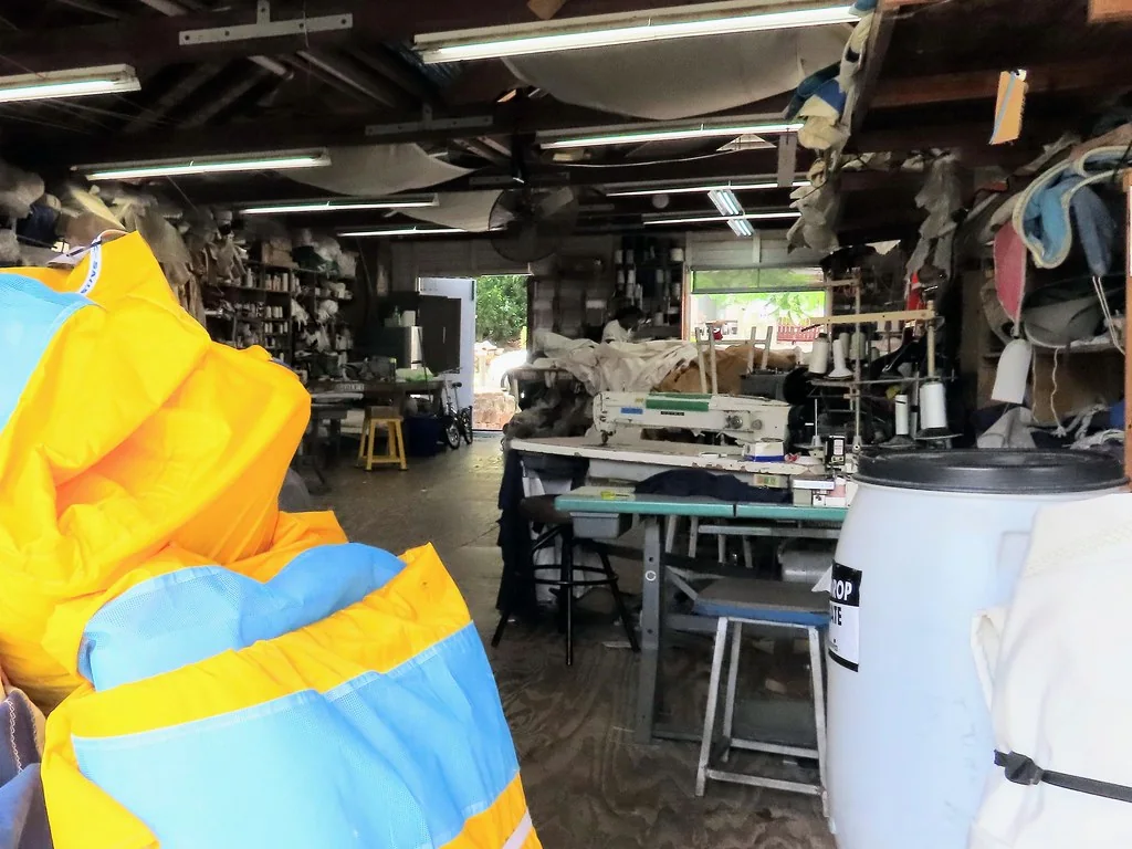 Sail-repair loft with sewing equipment and sailcloth in Antigua.